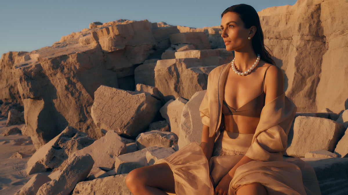 Model wearing a Paspaley South Sea pearl strand necklace against the natural landscape of the Kimberley, Western Australia