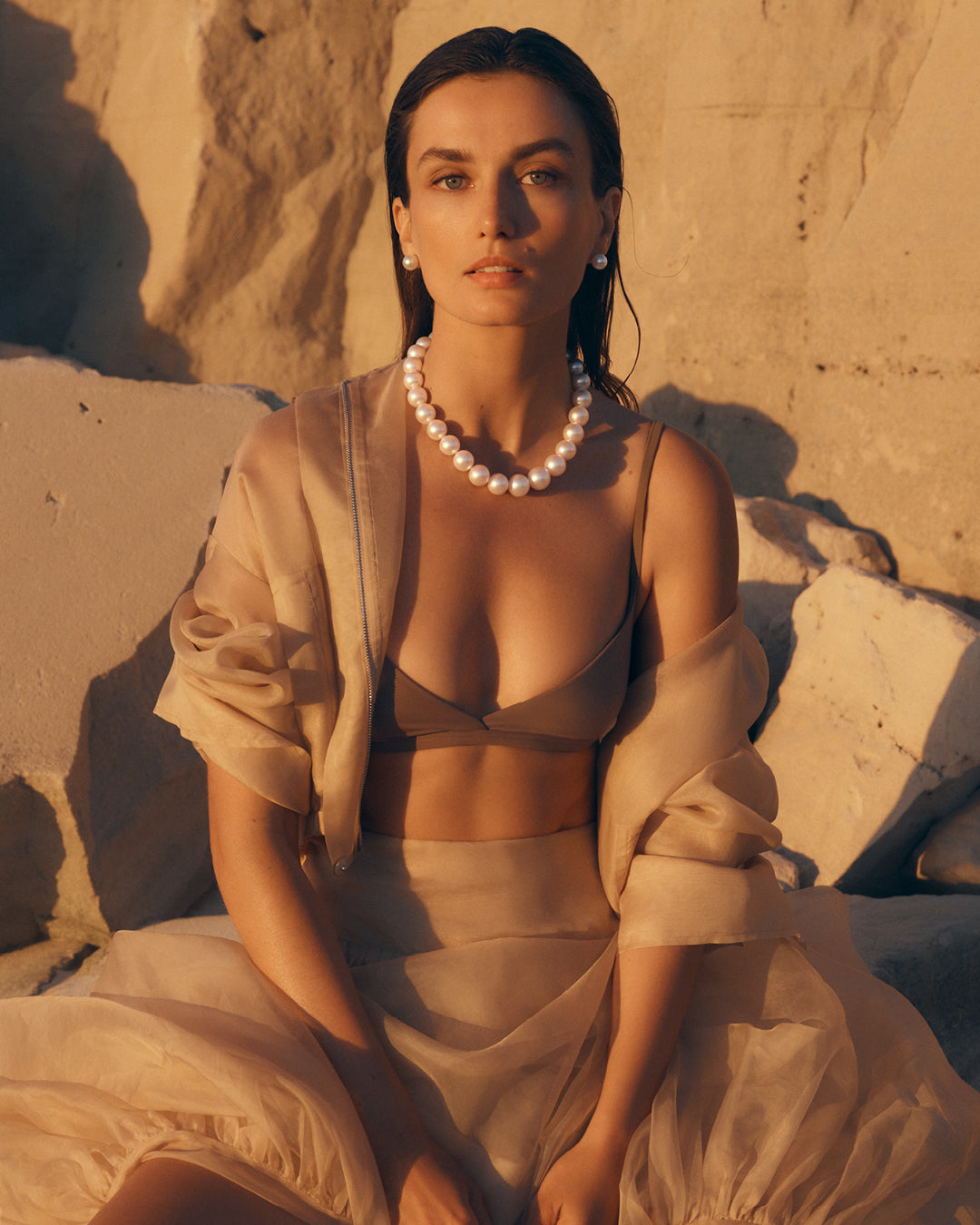 Model wearing a Paspaley South Sea pearl strand necklace against the natural landscape of the Kimberley, Western Australia