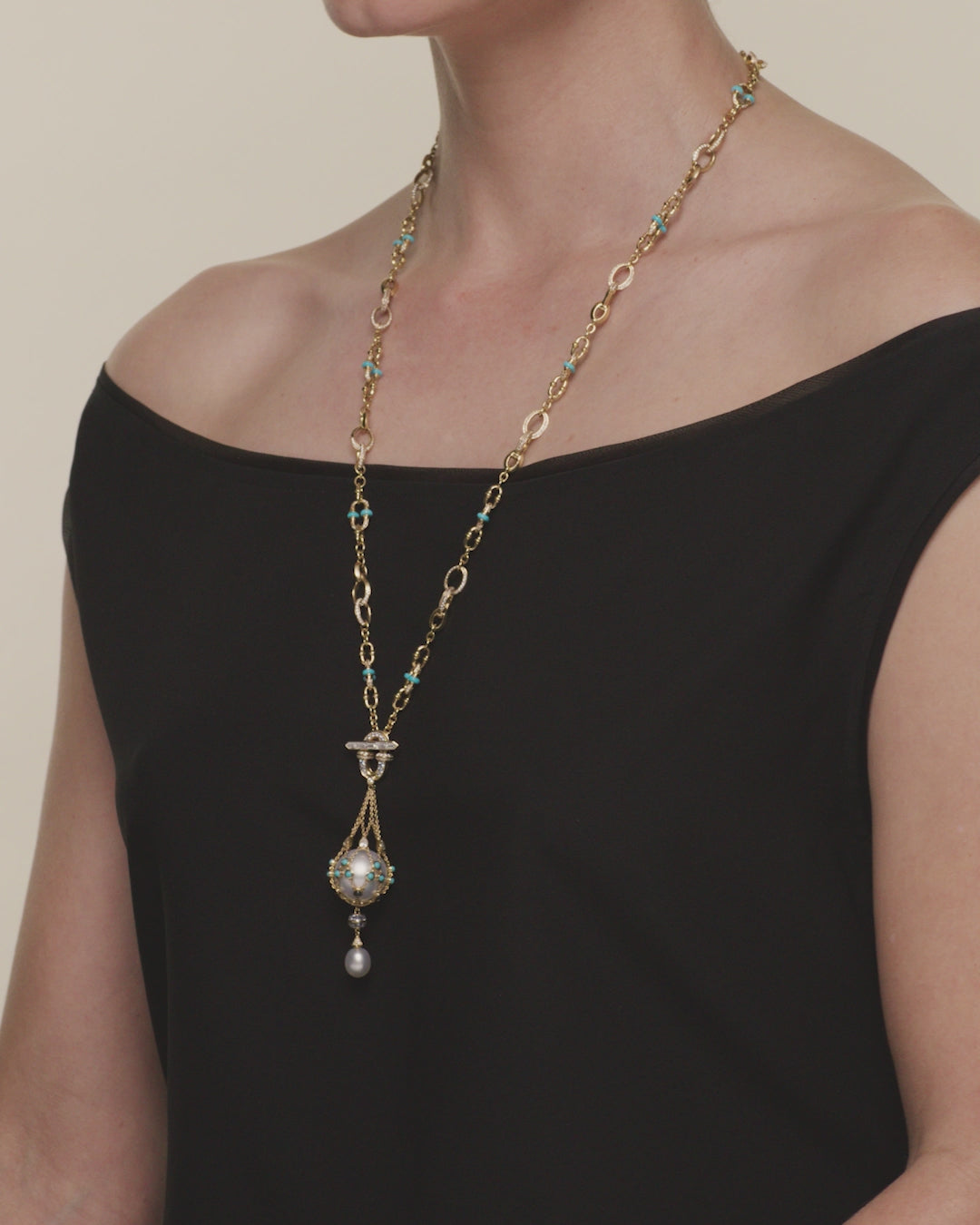 Turquoise anchored lavalier pearl necklace featuring an 18mm round South Sea pearl, blue sapphire and yellow gold