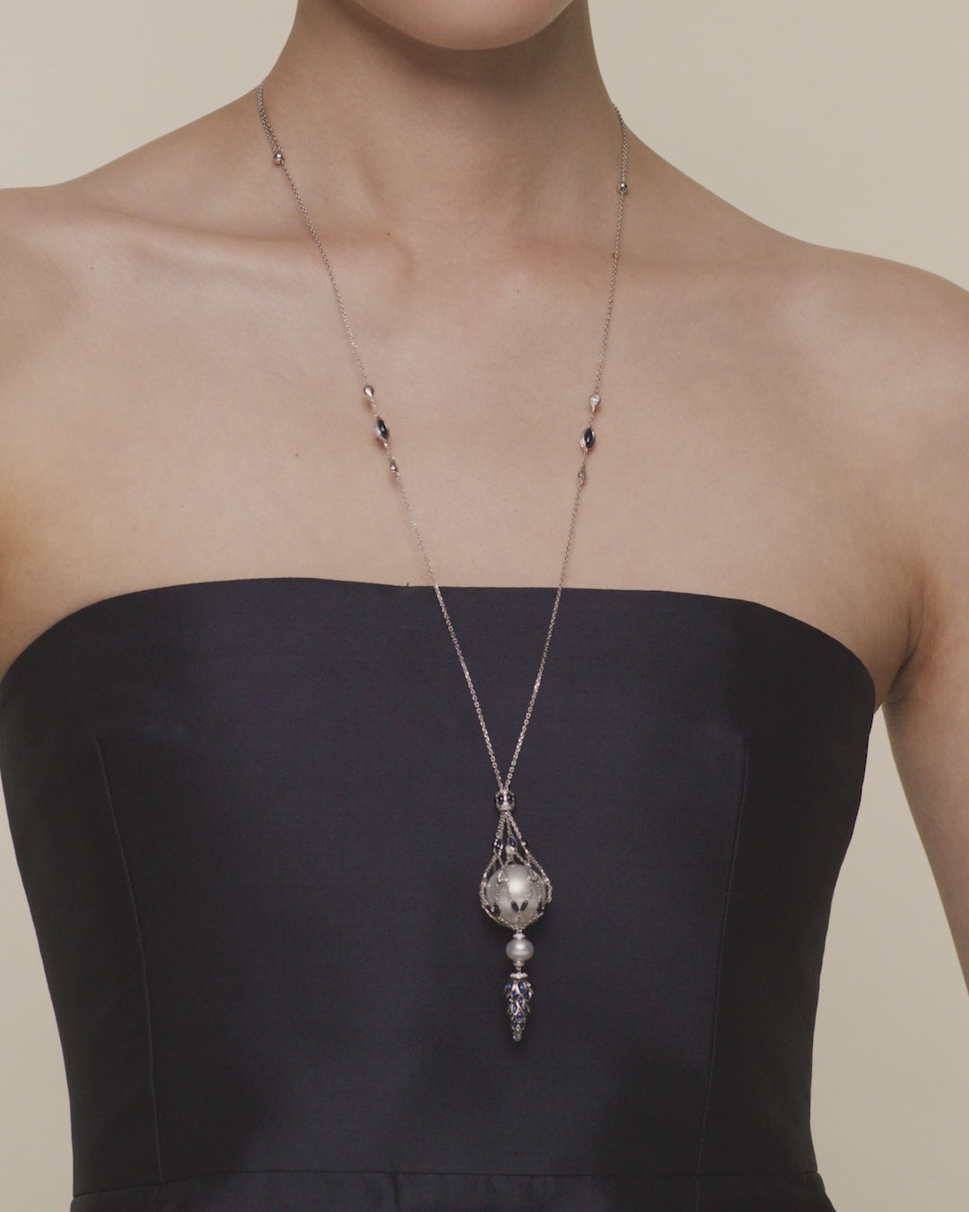 Blue sapphire hero lavalier pearl necklace featuring a 15mm round South Sea pearl, blue sapphires and white gold